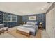 Bedroom featuring bold wallpaper, a blue bed frame, and light wood accents at 202 Mindy Dr, Largo, FL 33771