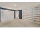 Large bedroom with open shelving, ample closet space and neutral carpeting at 202 Mindy Dr, Largo, FL 33771