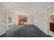 Bonus room with glass doors, kitchen access, neutral walls, and overhead lighting for a customizable space at 202 Mindy Dr, Largo, FL 33771