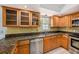 Classic kitchen featuring stainless steel appliances, granite countertops, and wooden cabinetry at 202 Mindy Dr, Largo, FL 33771