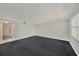 Bright living room with neutral colors, large windows, and access to other rooms and hallways at 202 Mindy Dr, Largo, FL 33771
