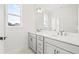Bright bathroom with double vanity, sleek fixtures, ample cabinet space, and natural light from a window at 2043 Wild Heron Ct, Valrico, FL 33596