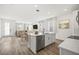 Bright, modern kitchen with white cabinetry, stainless steel appliances, and a large island at 2043 Wild Heron Ct, Valrico, FL 33596