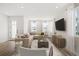 Open living room with a large sectional sofa, stylish decor, and plenty of natural light at 2043 Wild Heron Ct, Valrico, FL 33596