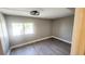 Bright bedroom featuring wood-look floors, natural light, and a modern ceiling fan at 2205 Belleair Rd # A36, Clearwater, FL 33764