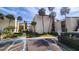 Building exterior with tropical landscaping, accessible parking, and guest seating at 2205 Belleair Rd # A36, Clearwater, FL 33764