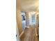 Hallway features wood-look floors, neutral walls, and access to multiple rooms at 2205 Belleair Rd # A36, Clearwater, FL 33764