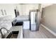 Modern kitchen featuring stainless steel appliances, white cabinetry, and stone countertops at 2205 Belleair Rd # A36, Clearwater, FL 33764