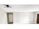 Open-concept living room with wood-look floors, neutral walls, and a modern ceiling fan at 2205 Belleair Rd # A36, Clearwater, FL 33764