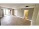 Spacious living room featuring luxury vinyl plank flooring and sliding glass doors to a balcony at 2205 Belleair Rd # A36, Clearwater, FL 33764