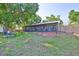Well maintained backyard features a screened in patio, mature trees, and a secure wooden fence at 22115 Laver Ln, Land O Lakes, FL 34639