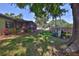 Spacious backyard showcases mature trees, a screened porch, garden decor, and a wooden fence at 22115 Laver Ln, Land O Lakes, FL 34639