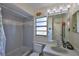 Bathroom featuring a shower-tub, a vanity with a mirror and decorative lighting at 22115 Laver Ln, Land O Lakes, FL 34639