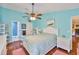 This bedroom offers a full-size bed, hardwood floors, and attached bathroom with shower at 22115 Laver Ln, Land O Lakes, FL 34639