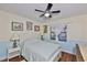Bedroom features hardwood floors, a window, ceiling fan and a bed with white accents at 22115 Laver Ln, Land O Lakes, FL 34639