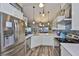 Bright kitchen featuring white cabinetry, stainless steel appliances, and a large island with sink at 22115 Laver Ln, Land O Lakes, FL 34639
