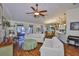 Open-concept living space with hardwood floors connecting to dining and kitchen areas at 22115 Laver Ln, Land O Lakes, FL 34639