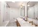 Bathroom with dual sinks, framed mirrors, and shower over tub at 2353 Dora Dr, Clearwater, FL 33765
