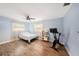 Bedroom featuring wood floors, ceiling fan, natural light, and light blue walls at 2353 Dora Dr, Clearwater, FL 33765