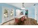 Charming dining room with modern furnishings, soft blue walls, and abundant natural light from the large doors at 2353 Dora Dr, Clearwater, FL 33765