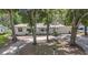 Charming single-story home with mature trees and a well-manicured front yard, painted a clean bright white at 2353 Dora Dr, Clearwater, FL 33765