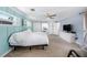 Spacious bedroom featuring bright blue walls, a ceiling fan, and large windows at 2353 Dora Dr, Clearwater, FL 33765