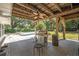 Covered patio featuring a ceiling fan, grill, and view of the pool at 2353 Dora Dr, Clearwater, FL 33765