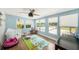 Bright playroom featuring wood floors, natural light, and views of the pool at 2353 Dora Dr, Clearwater, FL 33765