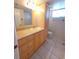 Well-lit bathroom with vanity, ample storage, and a shower-tub combination at 2424 W Tampa Bay Blvd # M-201, Tampa, FL 33607