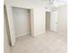 Clean bedroom featuring tile flooring, a ceiling fan, and a closet at 2424 W Tampa Bay Blvd # M-201, Tampa, FL 33607