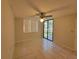 This is a bright bedroom featuring tile flooring, neutral walls, a ceiling fan, and sliding glass doors at 2424 W Tampa Bay Blvd # M-201, Tampa, FL 33607