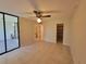 Bright bedroom featuring tile flooring, neutral walls, a ceiling fan, and a walk-in closet at 2424 W Tampa Bay Blvd # M-201, Tampa, FL 33607