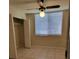 Bedroom featuring tile flooring, neutral walls, a ceiling fan, and a closet at 2424 W Tampa Bay Blvd # M-201, Tampa, FL 33607