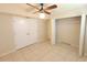 Bedroom featuring tile flooring, neutral walls, a ceiling fan, and a closet at 2424 W Tampa Bay Blvd # M-201, Tampa, FL 33607