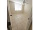 Bright bedroom with tile floors, a ceiling fan, and a window with blinds at 2424 W Tampa Bay Blvd # M-201, Tampa, FL 33607