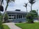 Exterior of a modern building surrounded by lush greenery and palm trees at 2424 W Tampa Bay Blvd # M-201, Tampa, FL 33607