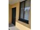 Exterior shot of the front door with decorative security door and adjacent window with blinds at 2424 W Tampa Bay Blvd # M-201, Tampa, FL 33607