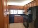 View of the kitchen area with cabinets, countertops, and black appliances at 2424 W Tampa Bay Blvd # M-201, Tampa, FL 33607