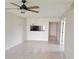 Open-concept living area features neutral walls, tile floors, and passthrough to the kitchen at 2424 W Tampa Bay Blvd # M-201, Tampa, FL 33607