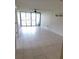 Spacious living room with sliding glass doors to the balcony and tiled flooring at 2424 W Tampa Bay Blvd # M-201, Tampa, FL 33607
