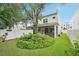 Spacious backyard with a mature tree, lush landscaping, and a screened-in lanai at 308 S New Jersey Ave # A, Tampa, FL 33609