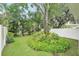Backyard featuring lush landscaping, mature trees, and a well-maintained lawn at 308 S New Jersey Ave # A, Tampa, FL 33609