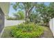Backyard featuring lush landscaping, a mature tree, and a well-maintained lawn at 308 S New Jersey Ave # A, Tampa, FL 33609