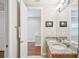 Bathroom featuring a granite vanity with double sinks, updated fixtures, and an open doorway at 308 S New Jersey Ave # A, Tampa, FL 33609