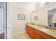 Bathroom includes double sinks, granite countertop, and wood cabinets at 308 S New Jersey Ave # A, Tampa, FL 33609