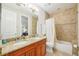 Bathroom with a granite vanity with double sinks, a toilet, and a shower with tile walls at 308 S New Jersey Ave # A, Tampa, FL 33609