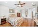 This secondary bedroom includes hard wood floors, a ceiling fan, and a chest of drawers at 308 S New Jersey Ave # A, Tampa, FL 33609