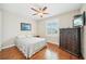 Bedroom with light-colored walls, a ceiling fan, and a window letting in natural light at 308 S New Jersey Ave # A, Tampa, FL 33609