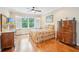 Cozy bedroom featuring hardwood floors, plantation shutters, and traditional furnishings at 308 S New Jersey Ave # A, Tampa, FL 33609