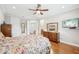 Bright bedroom featuring hard wood floors, ceiling fan, and attached full bathroom at 308 S New Jersey Ave # A, Tampa, FL 33609